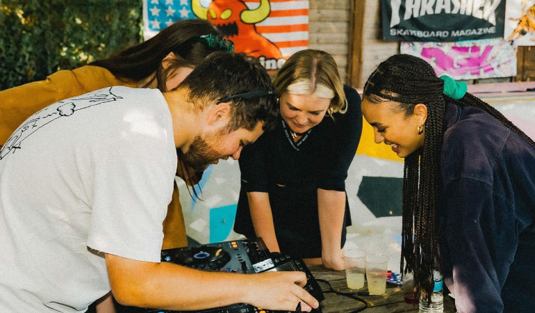 People Looking At Mixing Desk